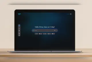 ממשק Alexa+ על מסך מחשב נייד, עם הברכה "Hello Olivia, how can I help?" ושורת חיפוש במרכז המסך